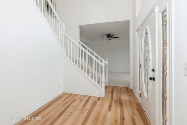 1110 Oakhill Dr, Aurora, IL 60502 - foyer with stairs, wood finished floors, ceiling fan, and baseboards