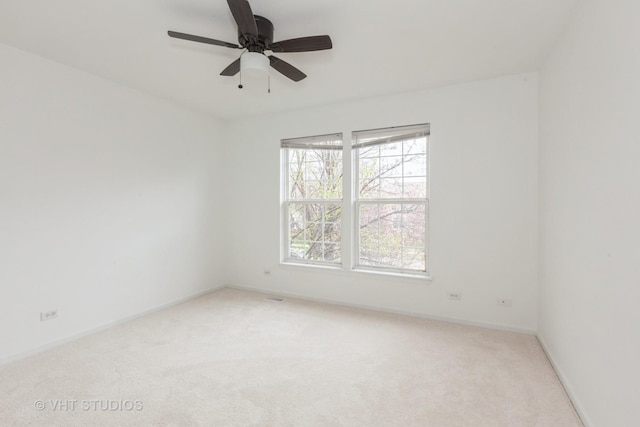 1110 Oakhill Dr, Aurora, IL 60502 - spare room featuring carpet, ceiling fan, and baseboards