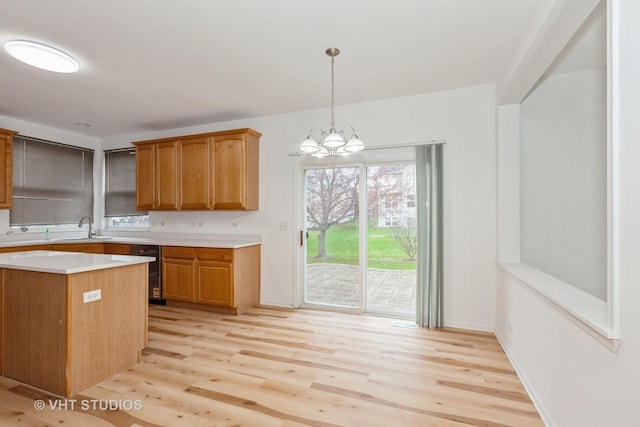 1110 Oakhill Dr, Aurora, IL 60502 - kitchen with light countertops, light wood-style floors, a sink, and decorative light fixtures