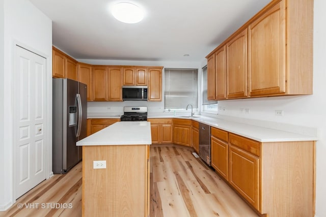 1110 Oakhill Dr, Aurora, IL 60502 - kitchen with appliances with stainless steel finishes, light wood finished floors, a sink, and light countertops