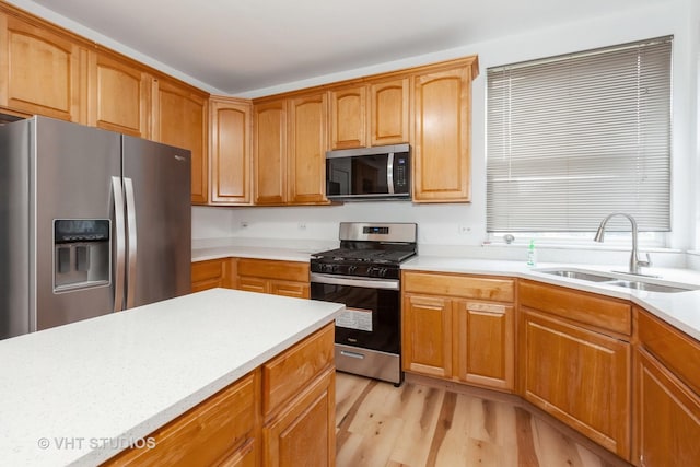 1110 Oakhill Dr, Aurora, IL 60502 - kitchen featuring stainless steel appliances, a sink, light wood-style floors, and light countertops
