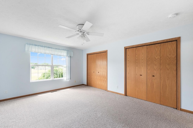 1424 Crimson Ridge Dr, Byron, IL 61010 - unfurnished bedroom featuring multiple closets, carpet floors, and ceiling fan
