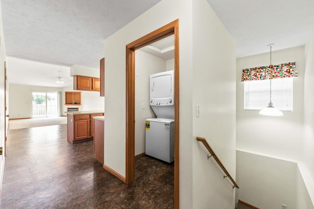 1424 Crimson Ridge Dr, Byron, IL 61010 - laundry area with stacked washer / dryer, a ceiling fan, and dark floors