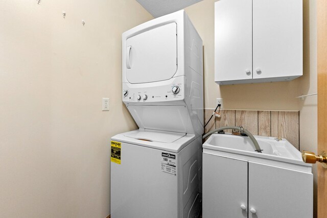 1424 Crimson Ridge Dr, Byron, IL 61010 - washroom with stacked washer and clothes dryer and cabinet space