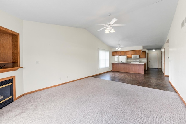 1424 Crimson Ridge Dr, Byron, IL 61010 - unfurnished living room with dark colored carpet, a ceiling fan, lofted ceiling, and a glass covered fireplace