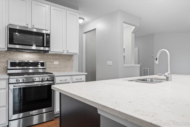 719 Foxborough Rd, South Elgin, IL 60177 - kitchen featuring stainless steel appliances, a sink, white cabinets, and decorative backsplash