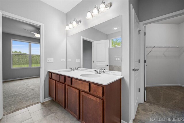 719 Foxborough Rd, South Elgin, IL 60177 - bathroom featuring double vanity, baseboards, and a spacious closet