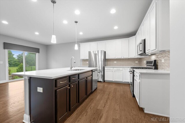 719 Foxborough Rd, South Elgin, IL 60177 - kitchen with appliances with stainless steel finishes, a sink, dark wood-type flooring, light countertops, and recessed lighting