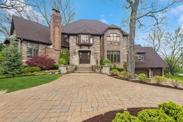 440 Woodside Ave, Hinsdale, IL 60521 - view of front of property with brick siding, a chimney, a garage, and driveway