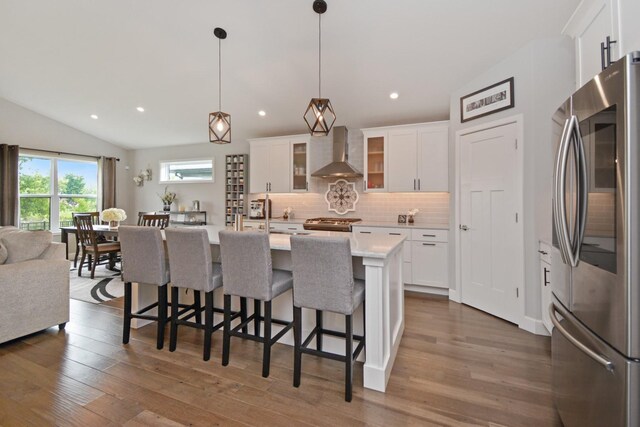1104 Hershey Rd, Normal, IL 61761 - kitchen featuring stainless steel appliances, wall chimney range hood, light countertops, open floor plan, and decorative backsplash