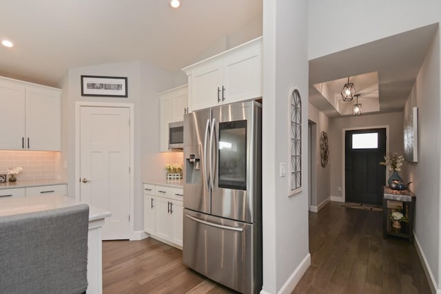 1104 Hershey Rd, Normal, IL 61761 - kitchen featuring appliances with stainless steel finishes, dark wood-type flooring, backsplash, white cabinetry, and recessed lighting
