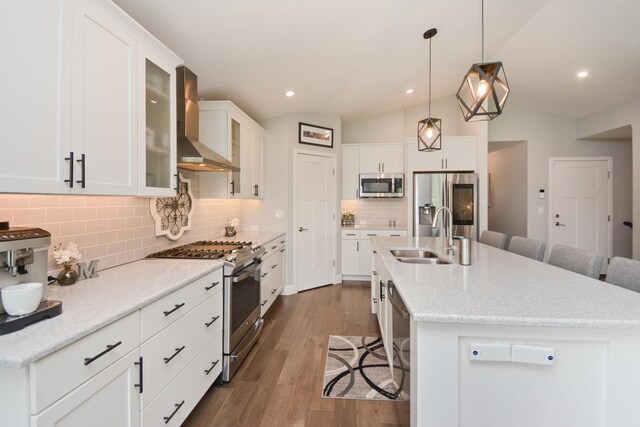 1104 Hershey Rd, Normal, IL 61761 - kitchen featuring stainless steel appliances, wall chimney range hood, a kitchen breakfast bar, lofted ceiling, and dark wood finished floors