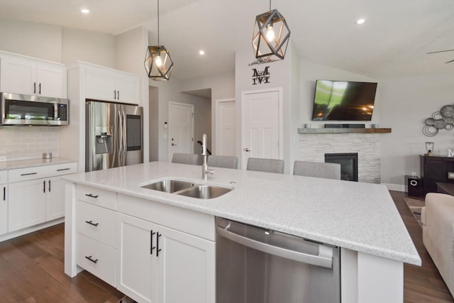 1104 Hershey Rd, Normal, IL 61761 - kitchen with stainless steel appliances, open floor plan, lofted ceiling, tasteful backsplash, and a kitchen island with sink