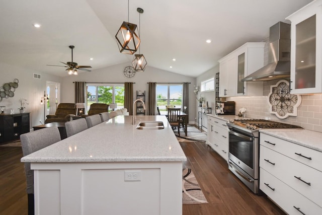 1104 Hershey Rd, Normal, IL 61761 - kitchen with wall chimney range hood, gas range, a kitchen island with sink, lofted ceiling, and dark wood-type flooring
