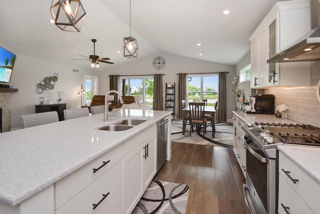 1104 Hershey Rd, Normal, IL 61761 - kitchen with wall chimney exhaust hood, appliances with stainless steel finishes, dark wood-style flooring, vaulted ceiling, and plenty of natural light