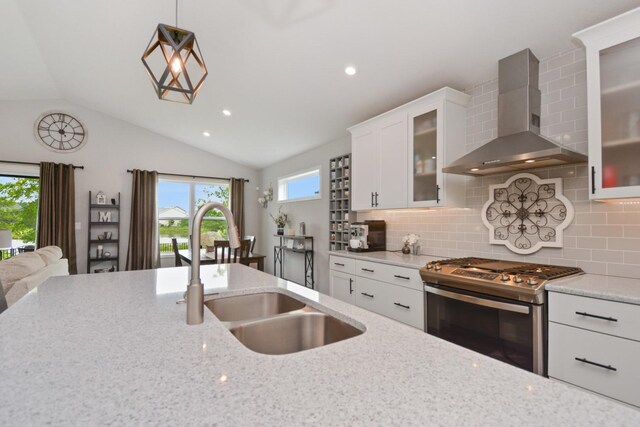 1104 Hershey Rd, Normal, IL 61761 - kitchen featuring wall chimney exhaust hood, stainless steel range with gas stovetop, light stone countertops, tasteful backsplash, and vaulted ceiling