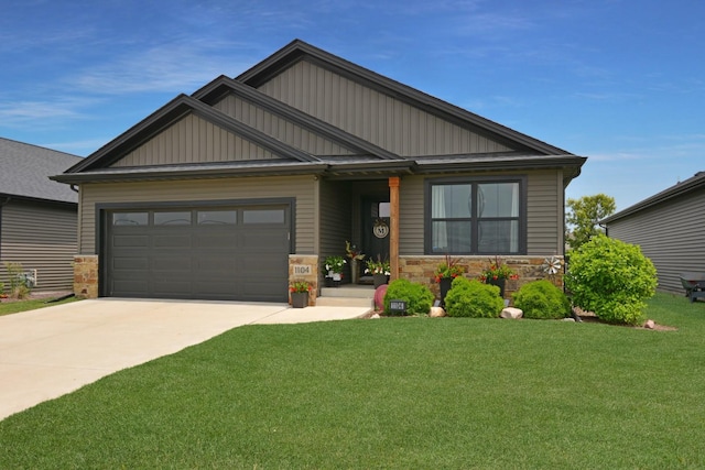 1104 Hershey Rd, Normal, IL 61761 - craftsman-style home with concrete driveway, stone siding, an attached garage, a front yard, and board and batten siding