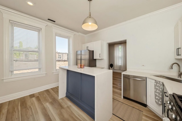 2515 W Augusta Blvd Unit 3S, Chicago, IL 60622 - kitchen with appliances with stainless steel finishes, a sink, plenty of natural light, white cabinetry, and ornamental molding