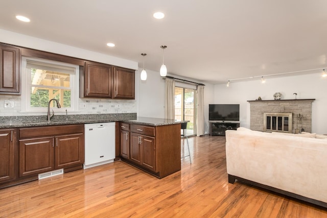 1504 Pfingsten Rd, Glenview, IL 60025 - kitchen with white dishwasher, light wood-style flooring, a peninsula, open floor plan, and tasteful backsplash