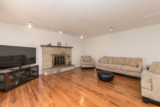 1504 Pfingsten Rd, Glenview, IL 60025 - living room with track lighting, wood finished floors, and a fireplace