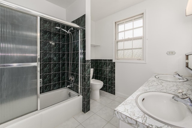 1504 Pfingsten Rd, Glenview, IL 60025 - full bathroom with combined bath / shower with glass door, tile patterned flooring, double vanity, and tile walls
