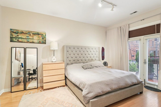 1347 W Washington Blvd Unit 2D, Chicago, IL 60607 - bedroom with light wood finished floors, access to exterior, and track lighting