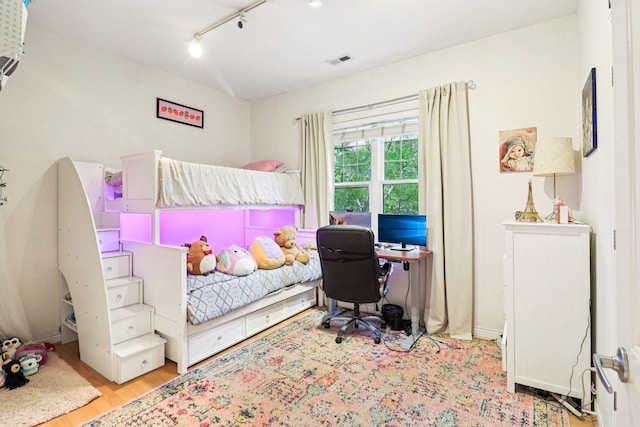 1347 W Washington Blvd Unit 2D, Chicago, IL 60607 - bedroom featuring rail lighting, wood finished floors, and a desk