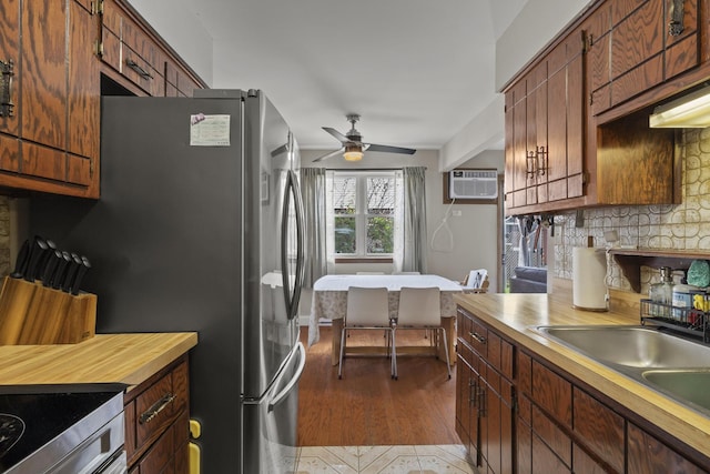 7250 W 84th St Unit C, Bridgeview, IL 60455 - kitchen with an AC wall unit, ceiling fan, light countertops, a sink, and decorative backsplash