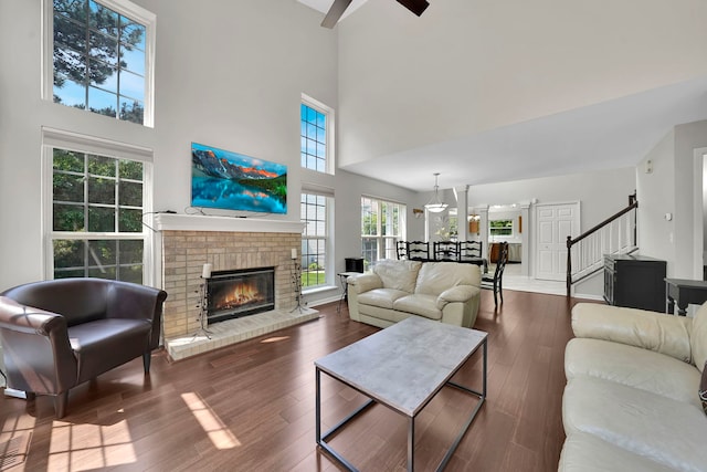 991 Willow St, Itasca, IL 60143 - living area featuring a high ceiling, a fireplace, dark wood-style floors, ceiling fan, and stairs