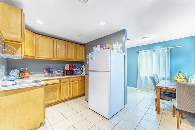 1209 Clark St, Joliet, IL 60432 - kitchen with freestanding refrigerator, light countertops, light tile patterned flooring, a sink, and stainless steel microwave