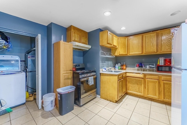 1209 Clark St, Joliet, IL 60432 - kitchen with stainless steel range with gas cooktop, washer / dryer, freestanding refrigerator, under cabinet range hood, and light countertops