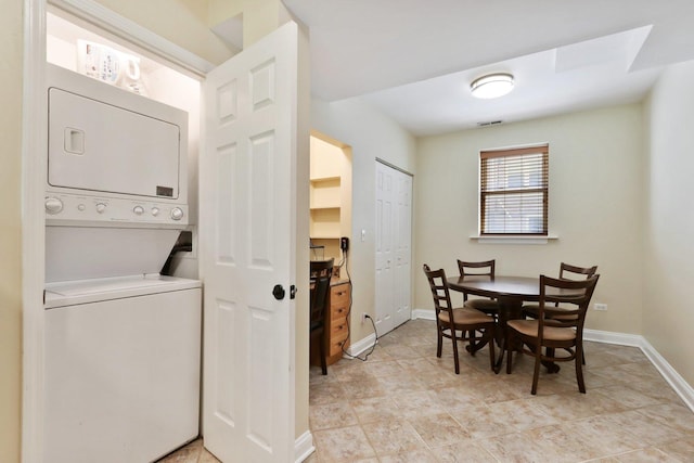 8911 Lamon Ave Unit A, Skokie, IL 60077 - laundry room featuring estacked washer and dryer and baseboards