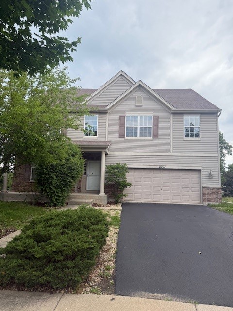 8307 Greenbridge Ct, Joliet, IL 60431 - view of front of home with a garage and asphalt driveway