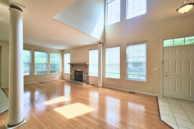 6 Clara Ct, Algonquin, IL 60102 - unfurnished living room featuring ornate columns, baseboards, healthy amount of natural light, and a high ceiling