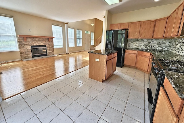 6 Clara Ct, Algonquin, IL 60102 - kitchen featuring black appliances, a kitchen island, light tile patterned floors, backsplash, and open floor plan