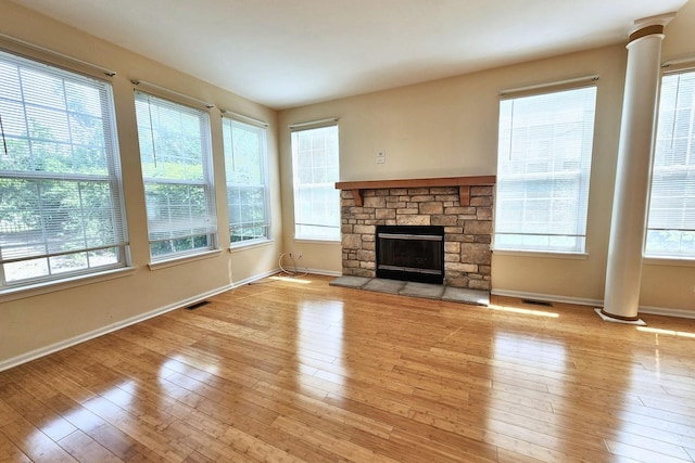 6 Clara Ct, Algonquin, IL 60102 - unfurnished living room with decorative columns, baseboards, light wood-style floors, and a fireplace