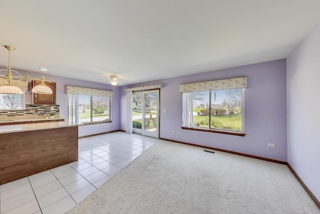 21436 W Larch Ct, Plainfield, IL 60544 - unfurnished living room with light tile patterned floors and baseboards