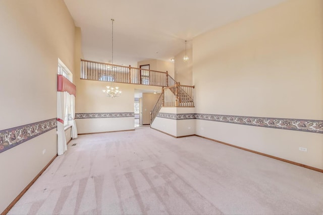 21436 W Larch Ct, Plainfield, IL 60544 - unfurnished living room with a chandelier, stairway, light carpet, a high ceiling, and baseboards