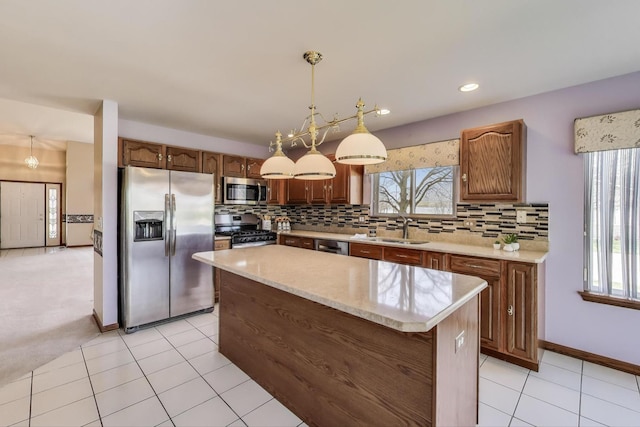 21436 W Larch Ct, Plainfield, IL 60544 - kitchen featuring stainless steel appliances, a sink, tasteful backsplash, a kitchen island, and decorative light fixtures