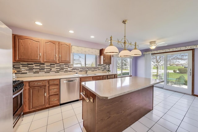 21436 W Larch Ct, Plainfield, IL 60544 - kitchen with stainless steel appliances, a sink, light countertops, tasteful backsplash, and a kitchen island