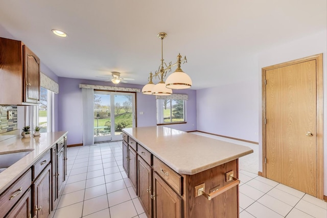 21436 W Larch Ct, Plainfield, IL 60544 - kitchen with a kitchen island, light countertops, a ceiling fan, light tile patterned flooring, and recessed lighting