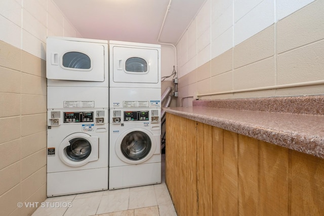 8473 Archer Ave Unit 204, Willow Springs, IL 60480 - community laundry room with stacked washing machine and dryer, light tile patterned floors, washing machine and dryer, and concrete block wall