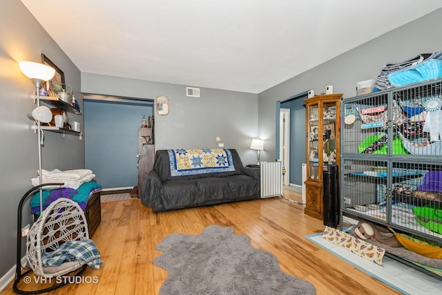 8473 Archer Ave Unit 204, Willow Springs, IL 60480 - living area featuring radiator heating unit and wood finished floors