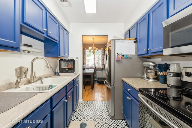 8473 Archer Ave Unit 204, Willow Springs, IL 60480 - kitchen featuring appliances with stainless steel finishes, blue cabinetry, a chandelier, and light countertops