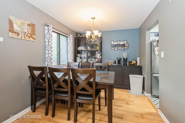 8473 Archer Ave Unit 204, Willow Springs, IL 60480 - dining area featuring a chandelier and light wood-type flooring