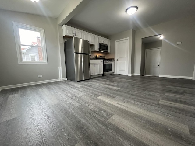 1204 N Park St, Streator, IL 61364 - kitchen with appliances with stainless steel finishes, dark wood-style floors, white cabinets, and baseboards