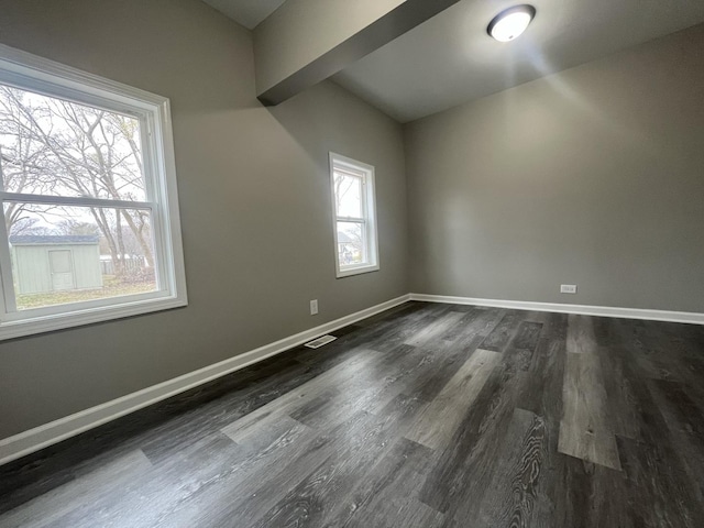 1204 N Park St, Streator, IL 61364 - unfurnished room with dark wood finished floors, baseboards, and vaulted ceiling