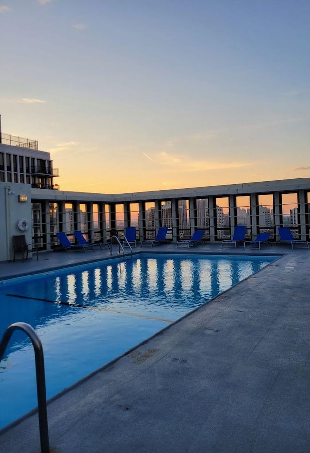 1 E Scott St Unit 1910, Chicago, IL 60610 - pool at dusk with a community pool and a patio
