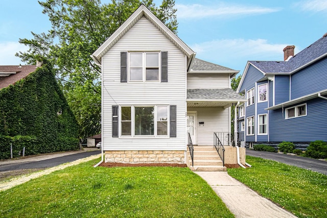207 Iowa Ave, Joliet, IL 60433 - traditional home with a front lawn and roof with shingles