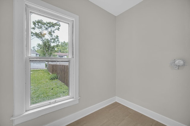 207 Iowa Ave, Joliet, IL 60433 - spare room featuring healthy amount of natural light, baseboards, and wood finished floors